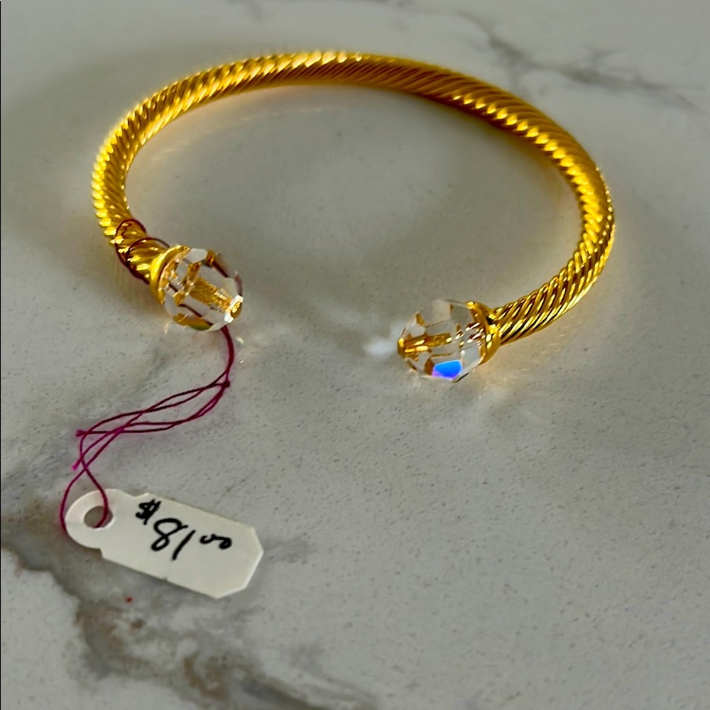 Elegant Gold-toned Bracelet with Swarovski clear Crystal stones.